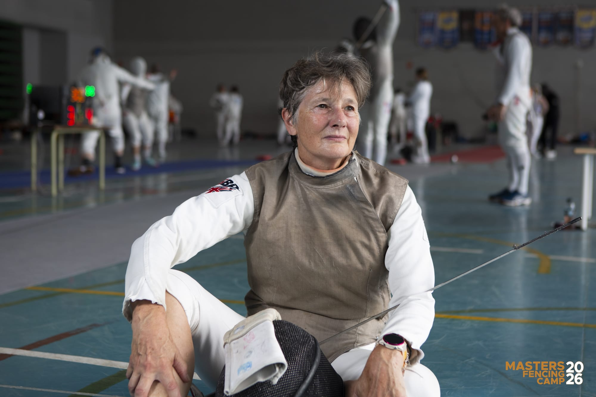 Caron Hale in veterans fencing kit at a fencing venue